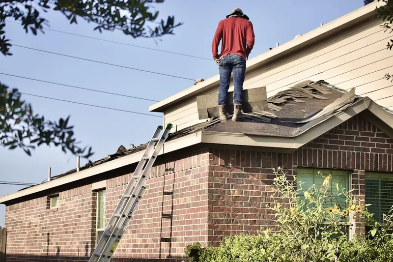 Professional roofer working on a residential roof in Grimes